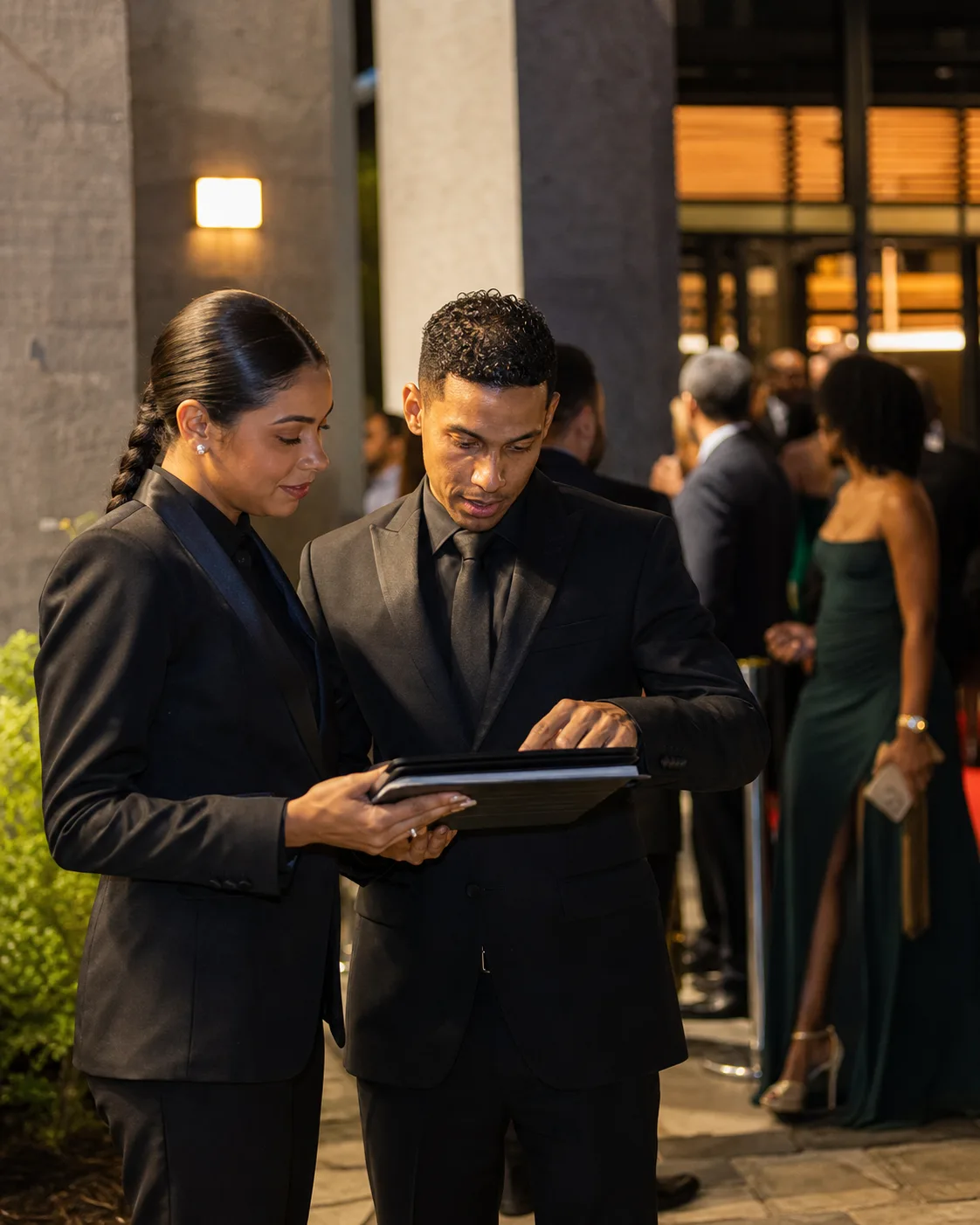 Event protocol team reviewing the guest list before a formal reception